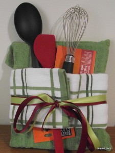 This is how you wrap a cook book! I purchased a pair of kitchen towels and folded them over the book.  Tucked in a couple utensils, and tied some ribbon around it.  If you need a quick and cute wedding shower gift idea, do this! 
