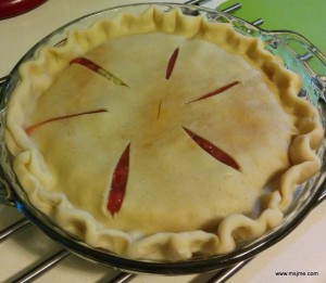 Place the top crust on and dress up the edges.  I pinch it with my fingers and use a knuckle as spacer.  It's not always the prettiest pie.  