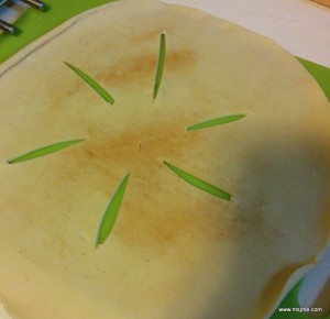 I prepare the top crust on a cutting board.  With a sharp knife I make the X in the middle and the slits.  It's a lot easier doing it before than when it's on the pie. 