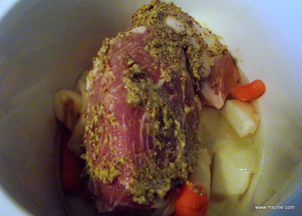 This photo doesn't make it very appealing, but this is how it "should" look in the crock pot.  I put the veggies in, add a cup of water, place the meat on top, sprinkle the seasoning salt and then rub 1-2 tbs of Boetje's onto the meat.  Then it's covered and cooked on the "LOW" setting for 6-8 hours. 