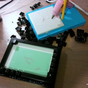 As you can see, my work space is messy.  I had an old keyboard and popped off the keys and glued them to a small frame (purchased at Dollar Tree).  I used black puffy paint to disguise the glue that seeped onto the frame. 